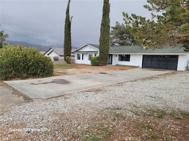 view of front of property with stucco siding, driveway, and a garage