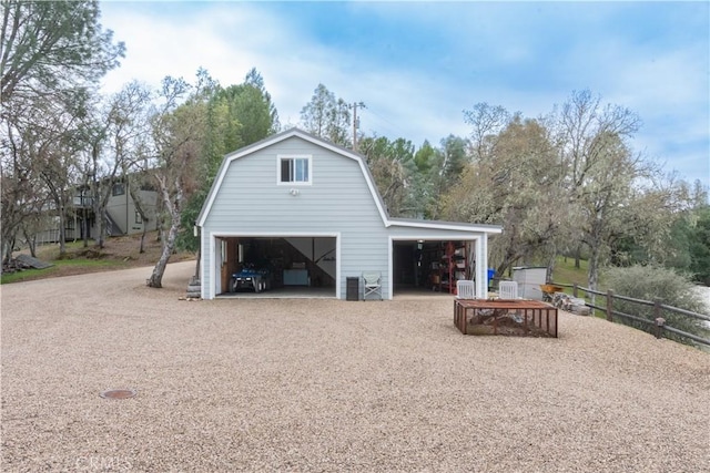 garage featuring central AC unit, a garage, and fence