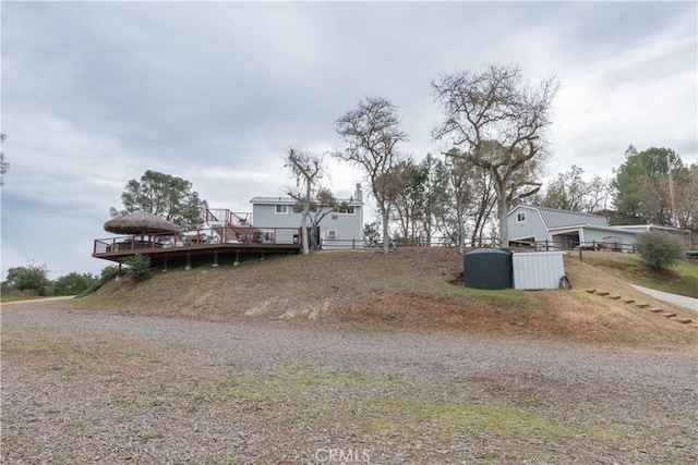 view of yard featuring fence and a wooden deck