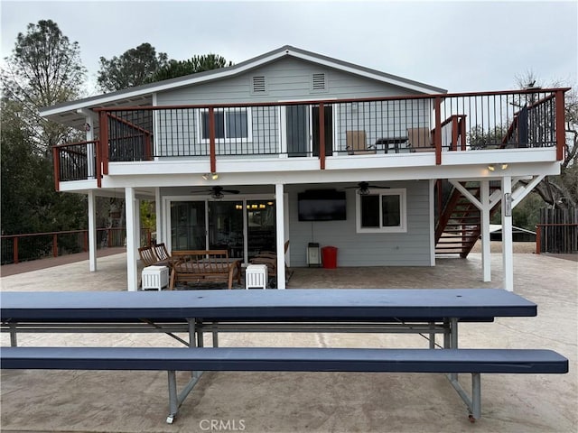 back of house with stairs, a patio, a wooden deck, and ceiling fan