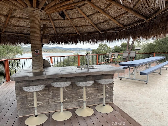 wooden deck featuring a sink, a gazebo, a mountain view, and outdoor dry bar