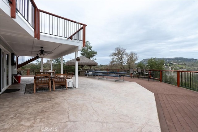 view of patio / terrace featuring a gazebo, a balcony, and a ceiling fan