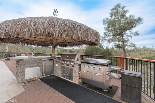 deck with a gazebo, area for grilling, and a sink