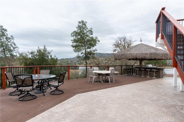 deck with outdoor dry bar and outdoor dining space