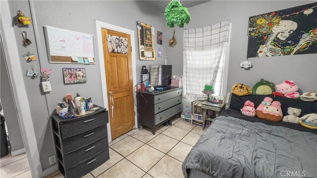 bedroom featuring light tile patterned flooring