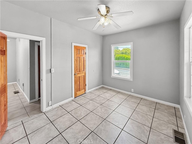 1685 Washington Ave, Oroville, CA 95966 - unfurnished bedroom featuring light tile patterned floors, a ceiling fan, and baseboards