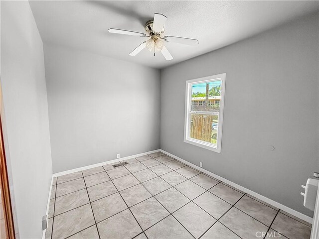 1685 Washington Ave, Oroville, CA 95966 - unfurnished room with light tile patterned flooring, a ceiling fan, and baseboards