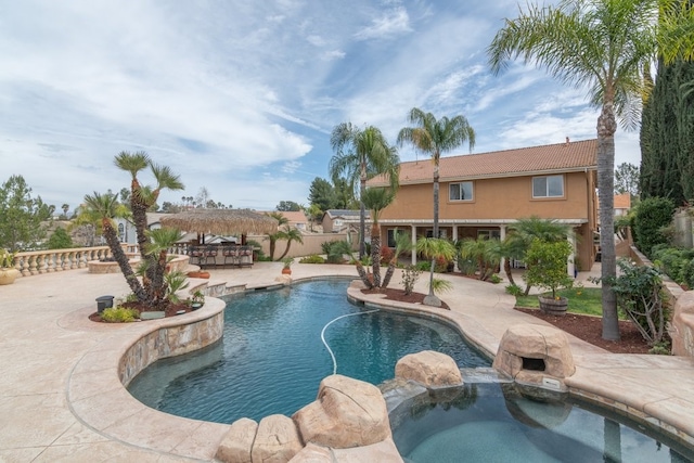 view of swimming pool with a patio and a pool with connected hot tub