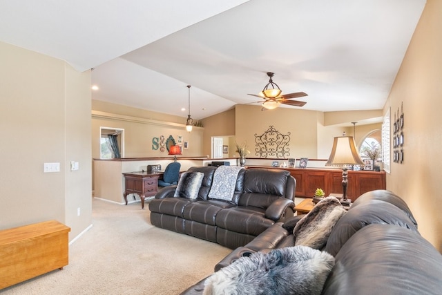 living area with lofted ceiling, a ceiling fan, baseboards, and light carpet