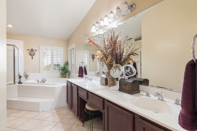 bathroom with double vanity, a stall shower, a sink, tile patterned flooring, and a garden tub