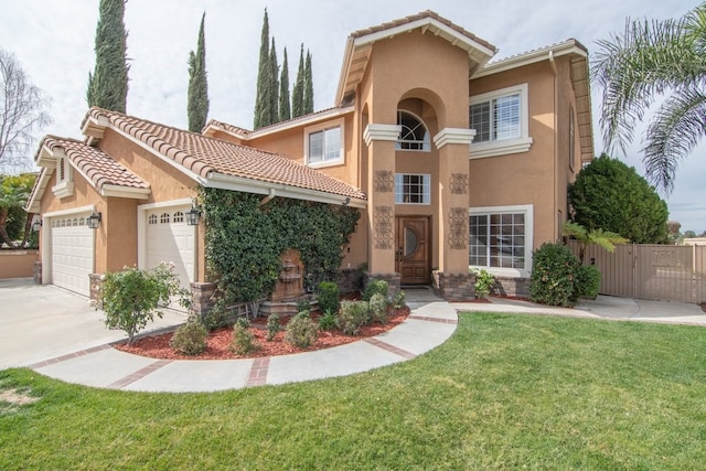 mediterranean / spanish house with fence, concrete driveway, a front yard, stucco siding, and an attached garage