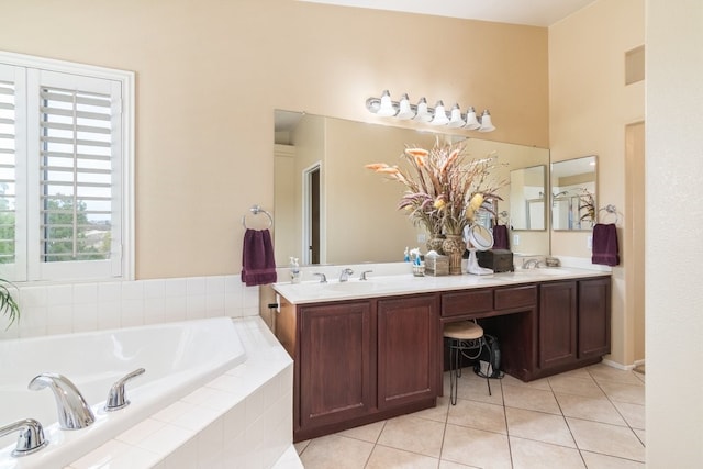 bathroom featuring tile patterned flooring, double vanity, a garden tub, and a sink