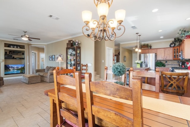 dining area with visible vents, ceiling fan with notable chandelier, and crown molding