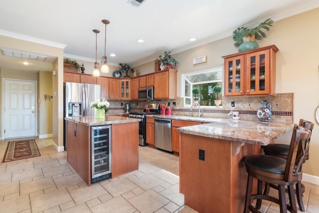 kitchen featuring visible vents, a peninsula, stainless steel appliances, wine cooler, and brown cabinets