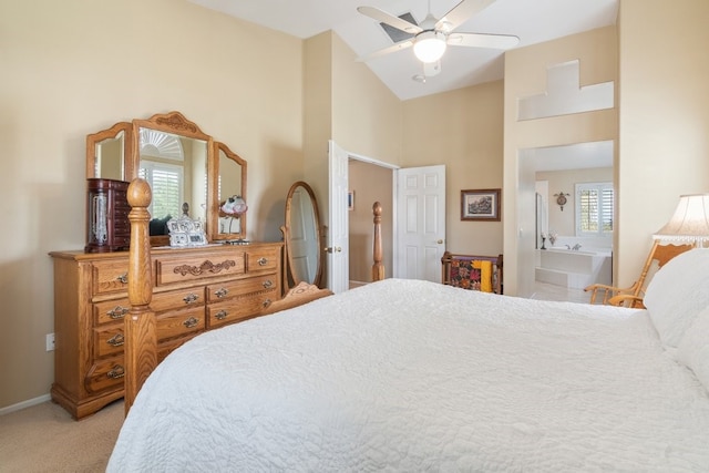 bedroom with high vaulted ceiling, baseboards, light colored carpet, and ensuite bathroom