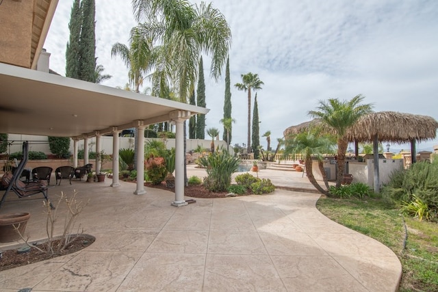 view of home's community featuring a patio and fence