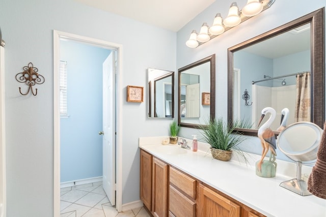 full bathroom featuring baseboards, vanity, and tile patterned flooring