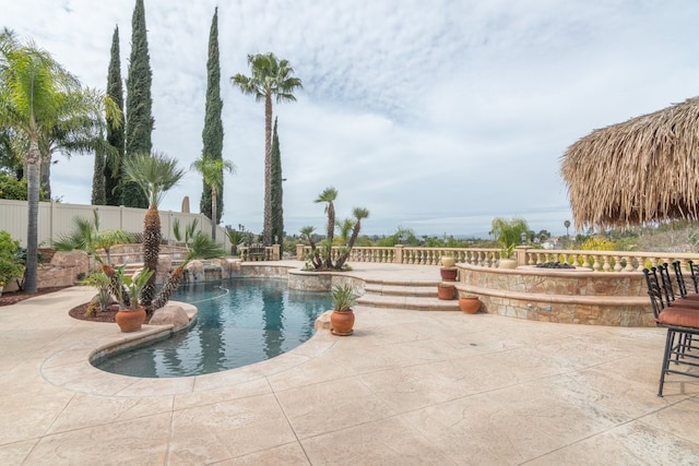 view of swimming pool featuring a fenced in pool, a patio area, and fence