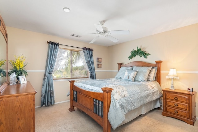 bedroom with a ceiling fan, baseboards, visible vents, and light carpet