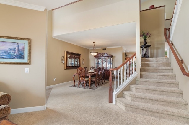 stairs featuring baseboards, carpet, and ornamental molding