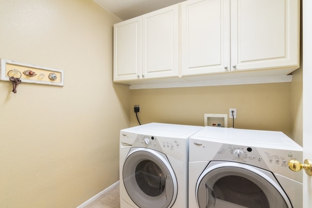 clothes washing area with cabinet space, washer and dryer, baseboards, and light tile patterned flooring