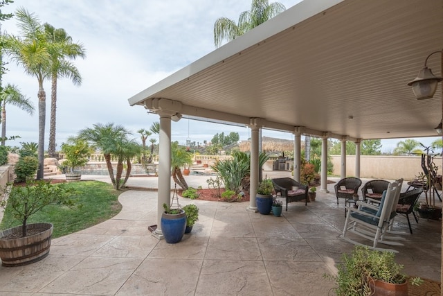 view of patio / terrace featuring fence