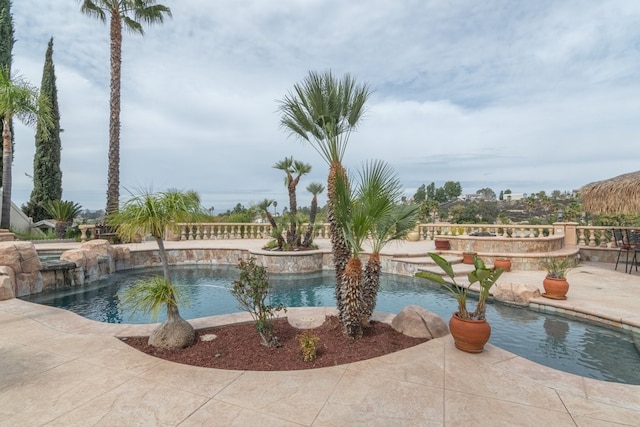 view of swimming pool with a pool with connected hot tub and a patio area