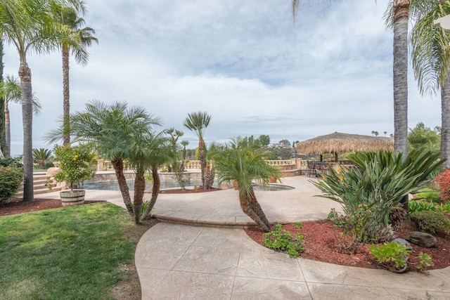 surrounding community featuring a patio area and a lawn