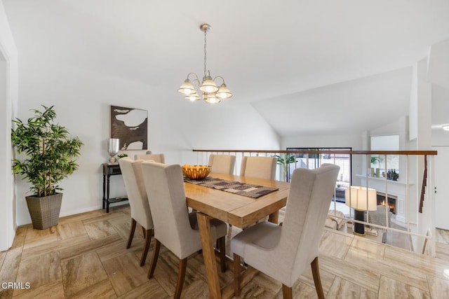 dining area with a chandelier and vaulted ceiling