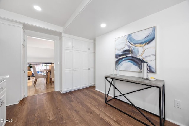 hallway with dark wood-style floors, recessed lighting, and baseboards