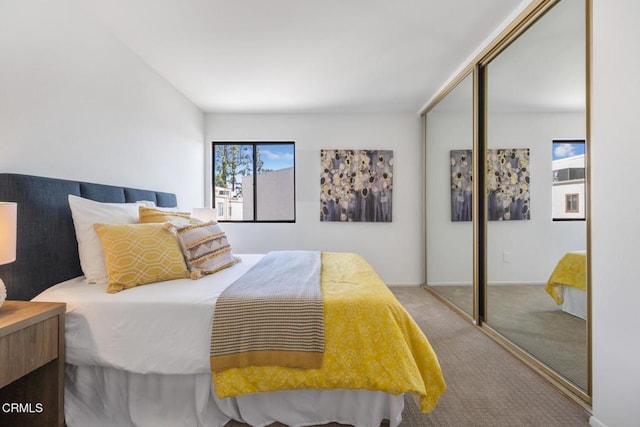 bedroom with baseboards, a closet, and carpet floors