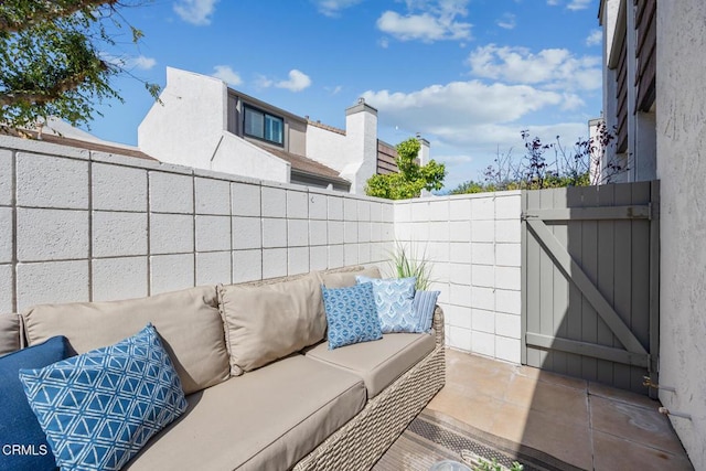 view of patio featuring outdoor lounge area, a gate, and a fenced backyard