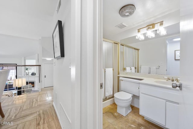 full bathroom with visible vents, toilet, a stall shower, and vanity