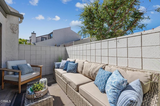 view of patio featuring an outdoor living space and fence