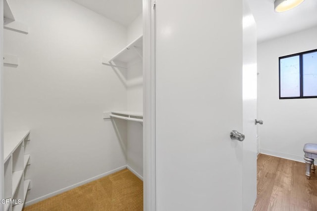 spacious closet featuring light wood-style floors