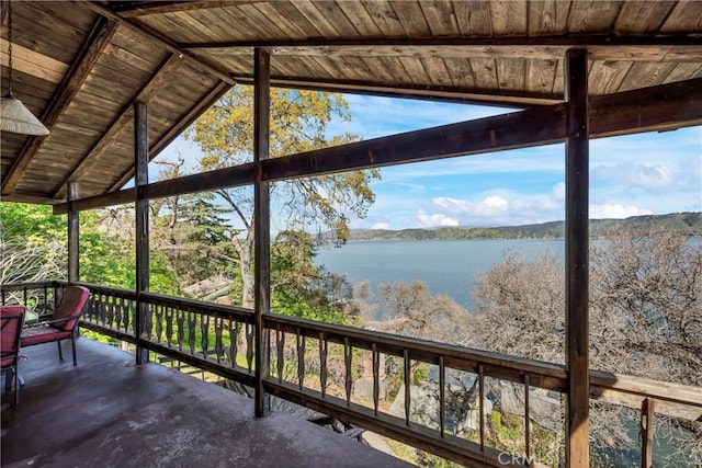 exterior space featuring a water view, lofted ceiling, and wood ceiling