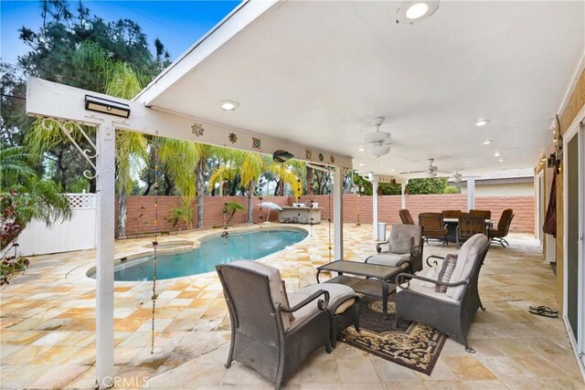 view of swimming pool featuring a fenced in pool, a patio, a ceiling fan, and a fenced backyard