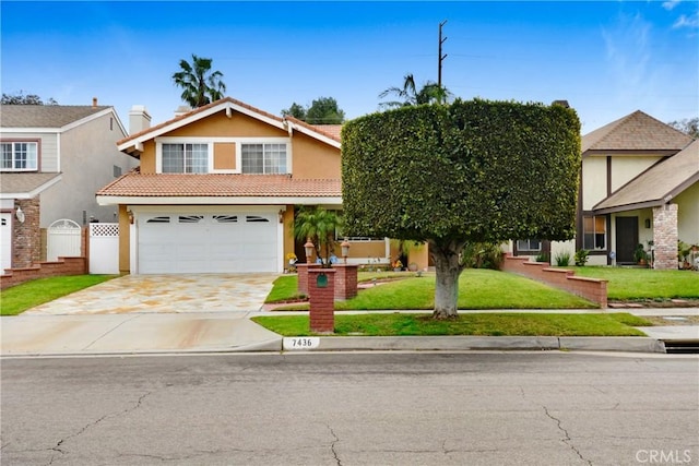 view of front of home featuring a front yard, fence, driveway, stucco siding, and a garage