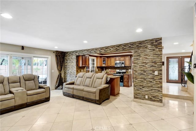 living area with recessed lighting, plenty of natural light, and light tile patterned flooring