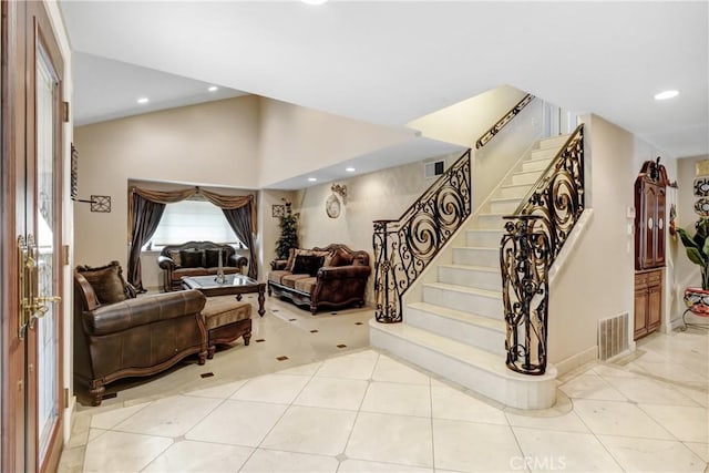 staircase with recessed lighting, visible vents, lofted ceiling, and tile patterned flooring