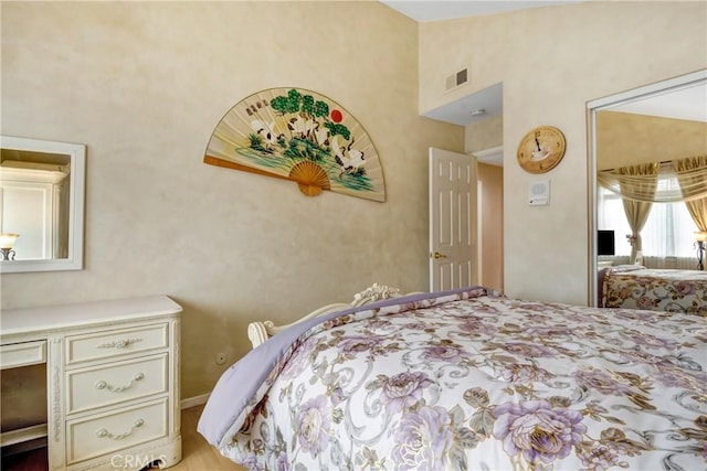 bedroom with lofted ceiling and visible vents