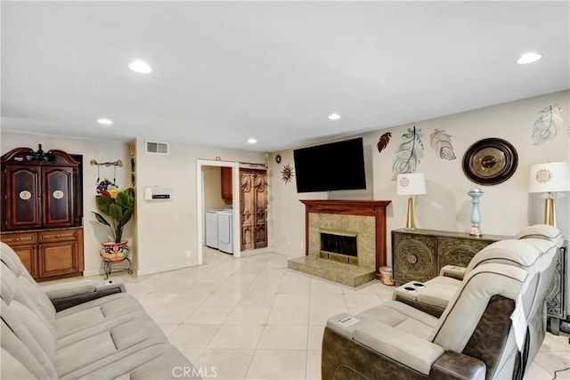 living area with a fireplace, light tile patterned floors, recessed lighting, and visible vents