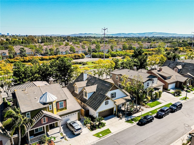 drone / aerial view featuring a residential view and a mountain view