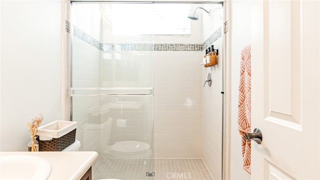 full bath with vanity, toilet, and a shower stall