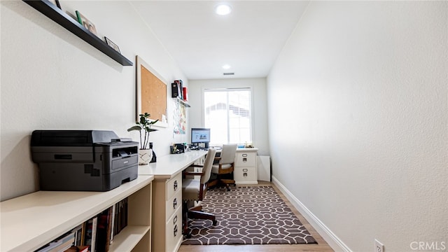 office space featuring visible vents, dark wood-type flooring, and baseboards