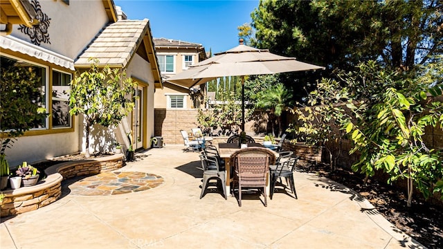 view of patio featuring outdoor dining space and fence