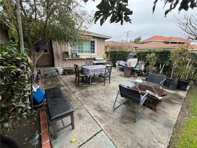 view of patio / terrace with an outbuilding, a fire pit, area for grilling, and outdoor dining space