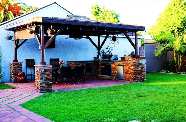 view of patio / terrace featuring a gazebo, grilling area, exterior kitchen, and outdoor wet bar