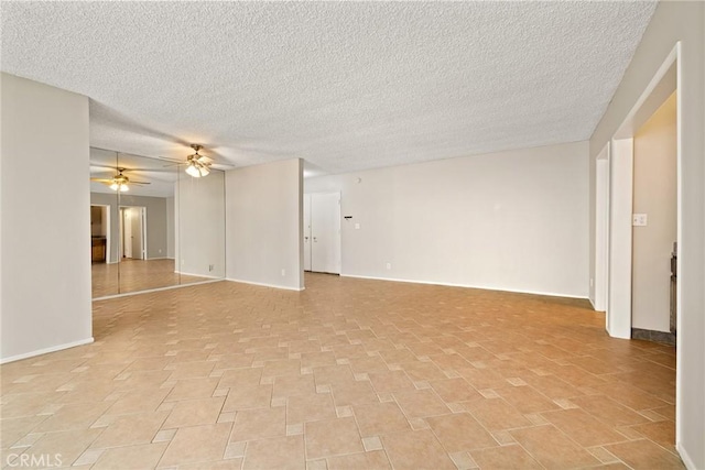 unfurnished living room with baseboards, a textured ceiling, and ceiling fan