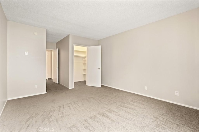 8701 Delgany Ave Unit 105, Playa Del Rey, CA 90293 - unfurnished bedroom featuring carpet, baseboards, a textured ceiling, a walk in closet, and a closet